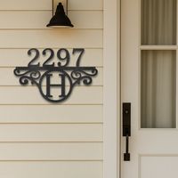 Custom metal house number steel sign with letter monogram set under the house numbers.
