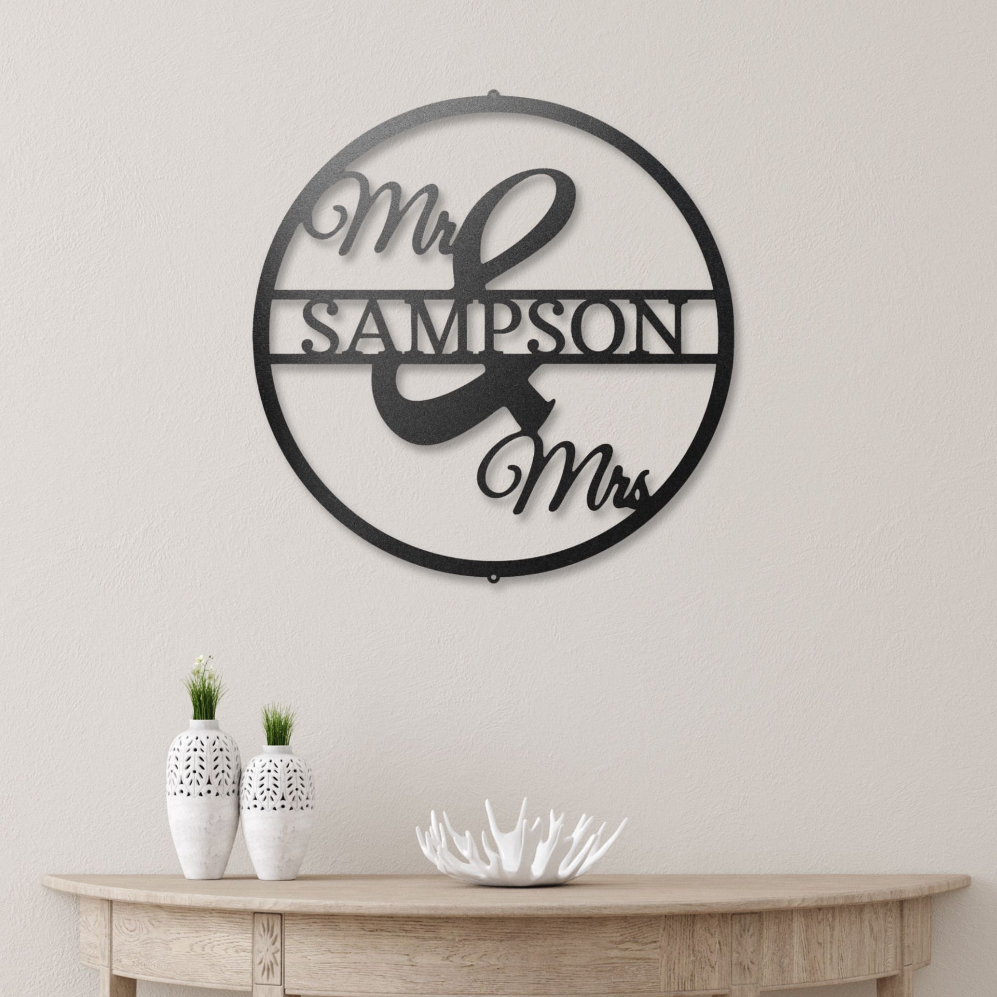 Mr and Mrs Circle steel sign in black finish displayed indoors