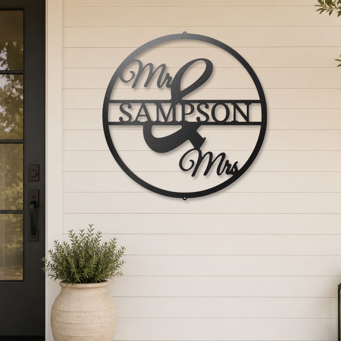 Mr and Mrs Circle steel sign in black finish displayed outdoors