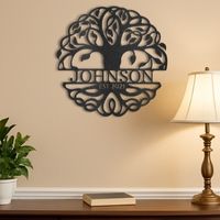 A custom metal sign with a family name displayed across metal wall art in the design of a Tree of Life piece of art.